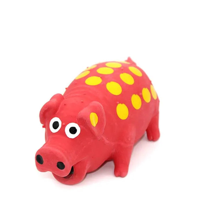Red pig-shaped squeaky dog toy with yellow spots, made of soft latex for fun chewing and interactive play